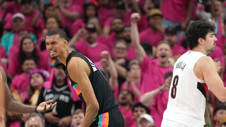 San Antonio Spurs forward Victor Wembanyama reacts after drawing a foul while scoring a basket during the second half of game one of the first round of the 2026 NBA Playoffs against the Portland Trail Blazers at Frost Bank Center. Mandatory Credit: Scott Wachter-Imagn Images