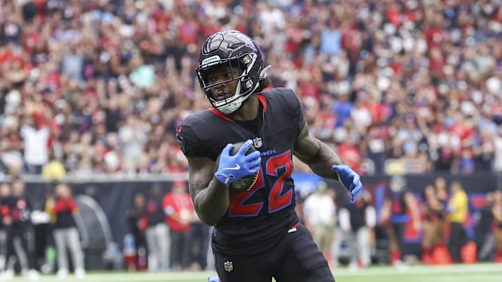 Oct 6, 2024; Houston, Texas, USA; Houston Texans running back Cam Akers (22) runs with the ball and scores a touchdown as Buffalo Bills cornerback Rasul Douglas (31) defends during the first quarter at NRG Stadium. Mandatory Credit: Troy Taormina-Imagn Images