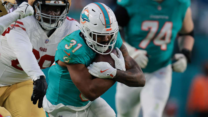 Dec 22, 2024; Miami Gardens, Florida, USA; Miami Dolphins running back Raheem Mostert (31) runs with the football past San Francisco 49ers safety Malik Mustapha (6) and safety Talanoa Hufanga (29) during the second quarter at Hard Rock Stadium. Mandatory Credit: Sam Navarro-Imagn Images