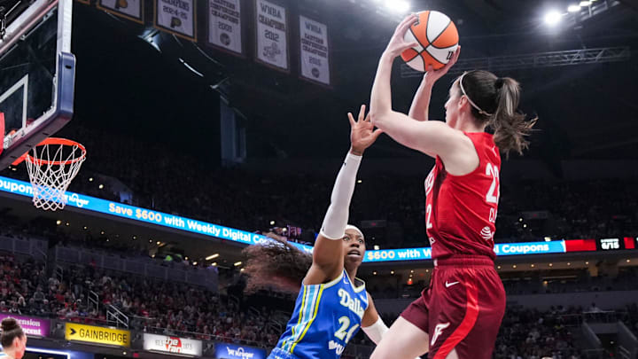 Indiana Fever guard Caitlin Clark (22) goes up for a basket against Dallas Wings guard Arike Ogunbowale (24) on Saturday, May 9, 2026, during the second half of the Fever’s season opener game at Gainbridge Fieldhouse in Indianapolis. The Dallas Wings defeated the Indiana Fever, 107-104.