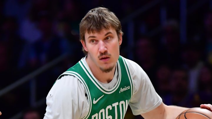 Feb 22, 2026; Los Angeles, California, USA; Boston Celtics guard Baylor Scheierman (55) controls the ball against the Los Angeles Lakers during the first half at Crypto.com Arena. Mandatory Credit: Gary A. Vasquez-Imagn Images