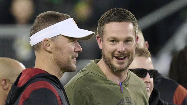 Nov 11, 2023; Eugene, Oregon, USA; USC Trojans head coach Lincoln Riley, left, and Oregon Ducks head coach Dan Lanning talk before a game at Autzen Stadium. Mandatory Credit: Troy Wayrynen-Imagn Images