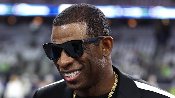 Nov 30, 2023; Arlington, Texas, USA; Colorado Buffaloes head coach Deion Sanders (right) talks with Dallas Cowboys owner Jerry Jones before the game against the Seattle Seahawks at AT&T Stadium. Mandatory Credit: Tim Heitman-Imagn Images