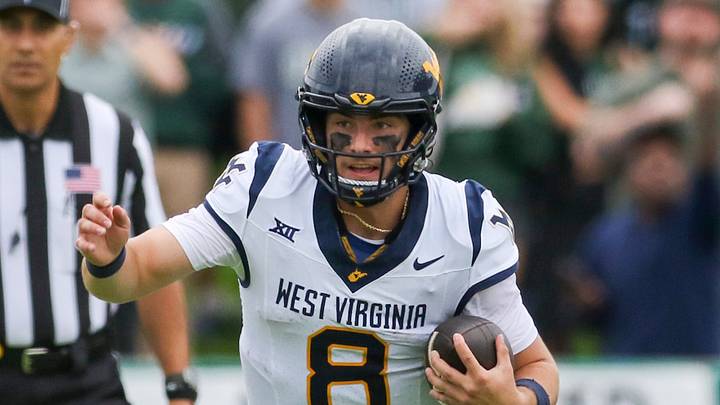 Sep 6, 2025; Athens, Ohio, USA; West Virginia Mountaineers quarterback Nicco Marchiol (8) runs the ball during the first quarter against the Ohio Bobcats at Peden Stadium. Mandatory Credit: Ben Queen-Imagn Images
