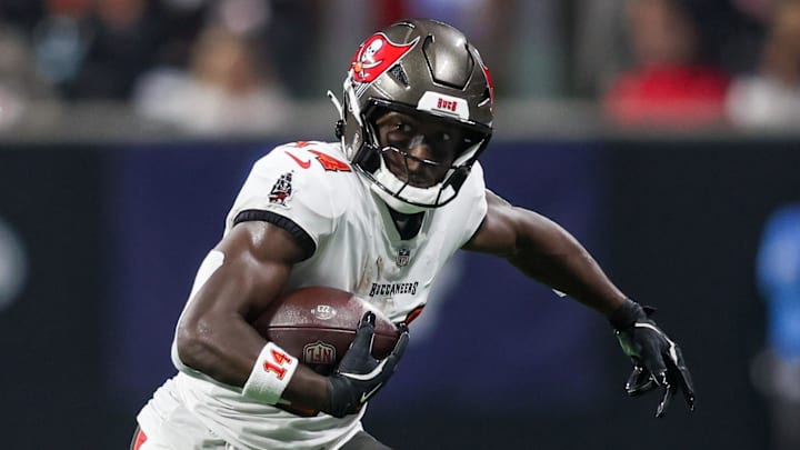 Oct 3, 2024; Atlanta, Georgia, USA; Tampa Bay Buccaneers wide receiver Chris Godwin (14) is pursued by Atlanta Falcons safety Justin Simmons (31) in the first quarter at Mercedes-Benz Stadium. Mandatory Credit: Brett Davis-Imagn Images