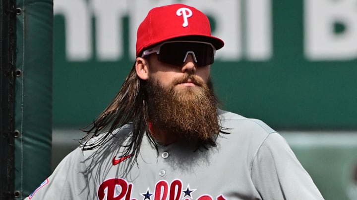 Apr 13, 2025; St. Louis, Missouri, USA; Philadelphia Phillies outfielder Brandon Marsh (16) braces himself against the screen after chasing a ball into the left field corner against the St. Louis Cardinals at Busch Stadium