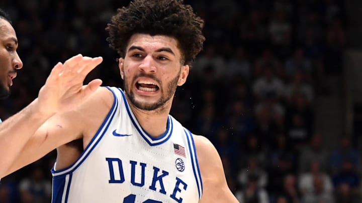 Mar 7, 2026; Durham, North Carolina, USA;Duke Blue Devils forward Cameron Boozer (12) drives to the basket as North Carolina Tar Heels forward Jarin Stevenson (15) defends during the second half at Cameron Indoor Stadium.  The Duke Blue Devils won 76-61. Mandatory Credit: Rob Kinnan-Imagn Images