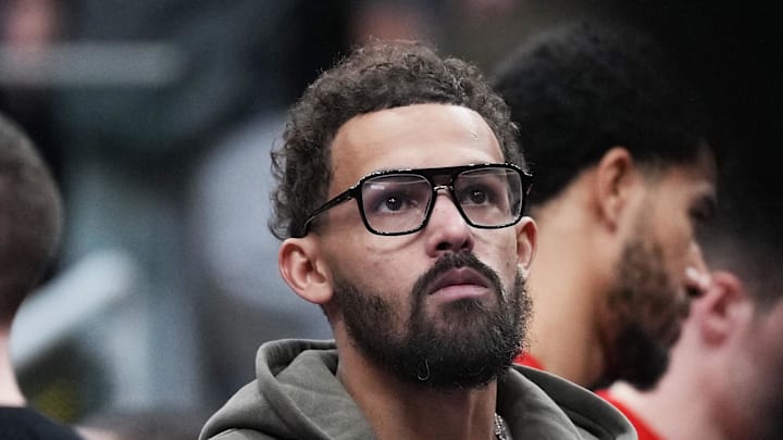 Atlanta Hawks guard Trae Young watches the game from the bench against the Toronto Raptors