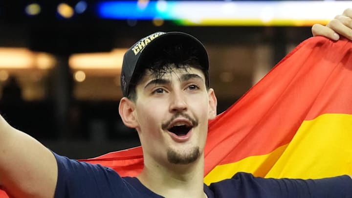 Indianapolis, IN, USA; Michigan Wolverines center Aday Mara (15) celebrates after cutting down a piece of the net after defeating the Connecticut Huskies in the national championship of the Final Four of the men's 2026 NCAA Tournament at Lucas Oil Stadium, Apr 6, 2026.