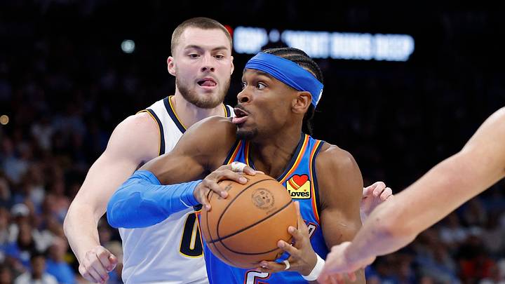 Mar 9, 2026; Oklahoma City, Oklahoma, USA; Oklahoma City Thunder guard Shai Gilgeous-Alexander (2) drives between Denver Nuggets guard Christian Braun (0) and forward Spencer Jones (21) during the second half at Paycom Center. Mandatory Credit: Alonzo Adams-Imagn Images