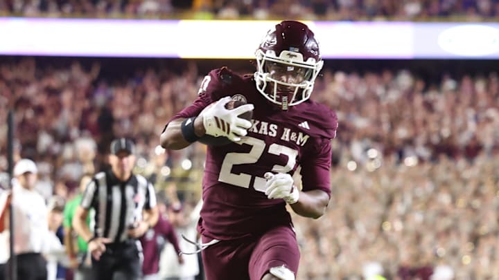 Texas A&M Aggies running back Jamarion Morrow (23) runs for a touchdown against Louisiana State Tigers linebacker Harold Perkins Jr. (7) during the second half at Tiger Stadium.