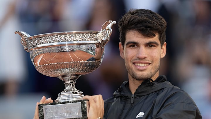 Carlos Alcaraz poses with the French Open 2024 trophy.