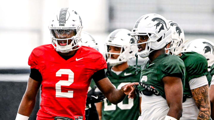 Michigan State quarterback Aidan Chiles, left, talks with Nick Marsh during a break in football practice on Tuesday, April 8, 2025, in East Lansing.