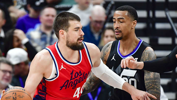 Feb 13, 2025; Salt Lake City, Utah, USA; LA Clippers center Ivica Zubac (40) turns into Utah Jazz forward/center John Collins (20) and forward/center Lauri Markkanen (23) during the first half at the Delta Center. Mandatory Credit: Christopher Creveling-Imagn Images
