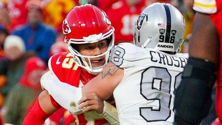 Nov 29, 2024; Kansas City, Missouri, USA; Kansas City Chiefs quarterback Patrick Mahomes (15) is sacked by Las Vegas Raiders defensive end Maxx Crosby (98) during the second half at GEHA Field at Arrowhead Stadium. Mandatory Credit: Denny Medley-Imagn Images