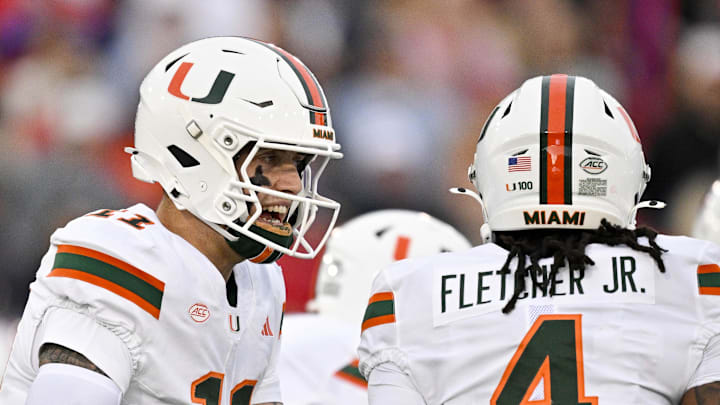 Nov 1, 2025; Dallas, Texas, USA; Miami Hurricanes quarterback Carson Beck (11) sets the play with running back Mark Fletcher Jr. (4) during the first quarter against the SMU Mustangs at Gerald J. Ford Stadium. Mandatory Credit: Jerome Miron-Imagn Images Nov 1, 2025; Dallas, Texas, USA; Miami Hurricanes quarterback Carson Beck (11) sets the play with running back Mark Fletcher Jr. (4) during the first quarter against the SMU Mustangs at Gerald J. Ford Stadium. Mandatory Credit: Jerome Miron-Imagn Images