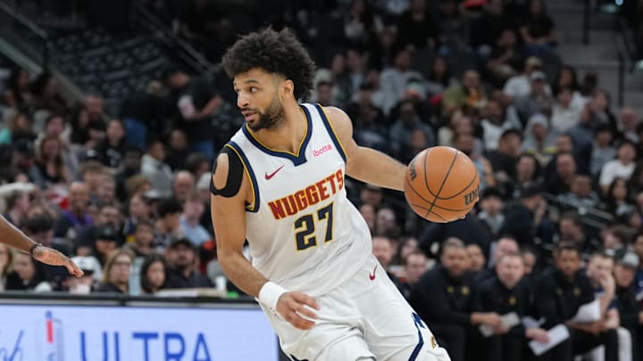 Mar 12, 2026; San Antonio, Texas, USA;  Denver Nuggets guard Jamal Murray (27) dribbles against San Antonio Spurs forward Mason Plumlee (45) in the first half at Frost Bank Center. Mandatory Credit: Daniel Dunn-Imagn Images