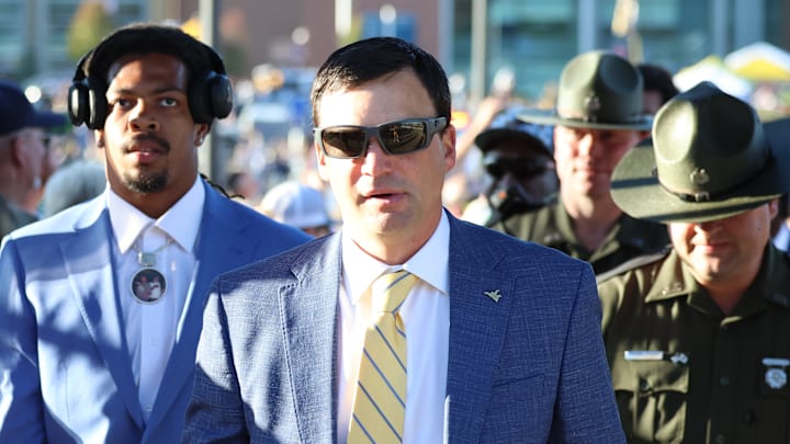 West Virginia University head coach Neal Brown with his son Dax. 