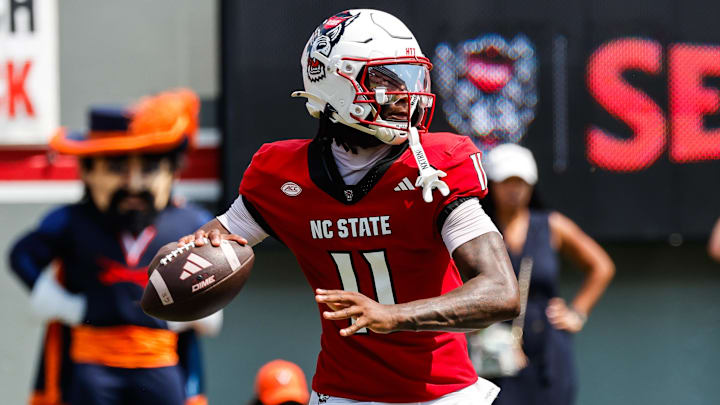 Sep 6, 2025; Raleigh, North Carolina, USA; North Carolina State Wolfpack quarterback CJ Bailey (11) prepares to throw the football during the first half of the game against Virginia Cavaliers at Carter-Finley Stadium. Mandatory Credit: Jaylynn Nash-Imagn Images