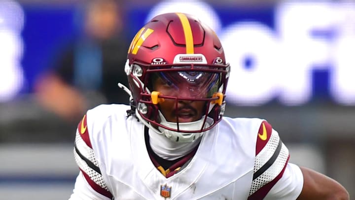 Washington Commanders quarterback Jayden Daniels runs against the Los Angeles Chargers.