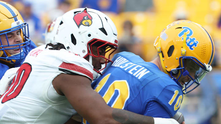 Sep 27, 2025; Pittsburgh, Pennsylvania, USA; Louisville Cardinals defensive lineman Rene Konga (90) sacks Pittsburgh Panthers quarterback Eli Holstein (10) during the fourth quarter at Acrisure Stadium. Mandatory Credit: Charles LeClaire-Imagn Images
