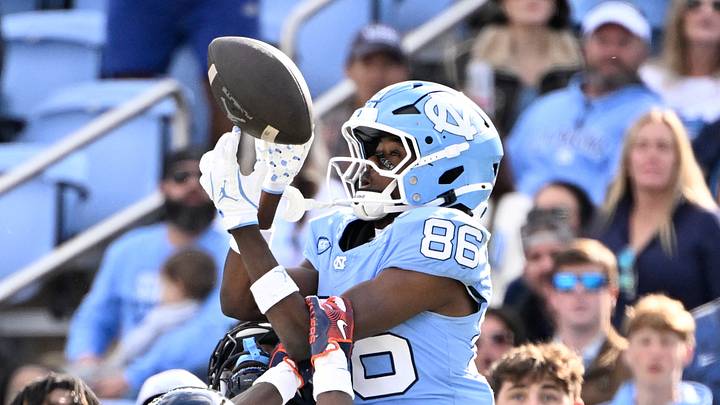 Oct 25, 2025; Chapel Hill, North Carolina, USA; Virginia Cavaliers safety Antonio Clary (0) intercepts a pass intended for North Carolina Tar Heels wide receiver Madrid Tucker (86) as cornerback Emmanuel Karnley (19) helps defend near the end of the fourth quarter at Kenan Stadium. Mandatory Credit: Bob Donnan-Imagn Images Oct 25, 2025; Chapel Hill, North Carolina, USA; Virginia Cavaliers safety Antonio Clary (0) intercepts a pass intended for North Carolina Tar Heels wide receiver Madrid Tucker (86) as cornerback Emmanuel Karnley (19) helps defend near the end of the fourth quarter at Kenan Stadium. Mandatory Credit: Bob Donnan-Imagn Images