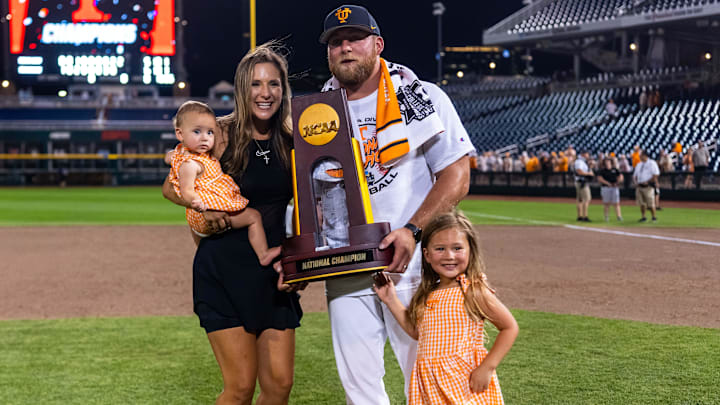 Jun 24, 2024; Omaha, NE, USA; Tennessee Volunteers assistant coach Josh Elander holds the national championship trophy with family after defeating the Texas A&M Aggies at Charles Schwab Field Omaha. Mandatory Credit: Dylan Widger-Imagn Images Jun 24, 2024; Omaha, NE, USA; Tennessee Volunteers assistant coach Josh Elander holds the national championship trophy with family after defeating the Texas A&M Aggies at Charles Schwab Field Omaha. Mandatory Credit: Dylan Widger-Imagn Images