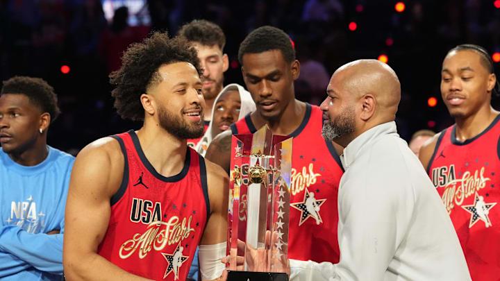 Feb 15, 2026; Inglewood, California, USA; Team USA Stars guard Cade Cunningham (2) of the Detroit Pistons and head coach J. B. Bickerstaff lift the trophy during the 75th NBA All Star Game at Intuit Dome. Mandatory Credit: Kirby Lee-Imagn Images