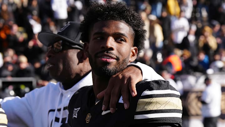 Nov 29, 2024; Boulder, Colorado, USA; Colorado Buffaloes quarterback Shedeur Sanders (2) and head coach Deion Sanders ifollowing the win over the Oklahoma State Cowboys at Folsom Field. Mandatory Credit: Ron Chenoy-Imagn Images