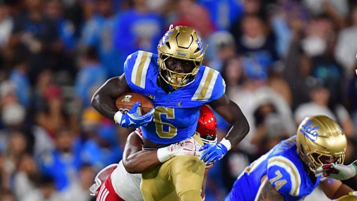 Aug 30, 2025; Pasadena, California, USA; UCLA Bruins running back Anthony Woods (6) runs the ball against the Utah Utes during the first half at Rose Bowl. Mandatory Credit: Gary A. Vasquez-Imagn Images