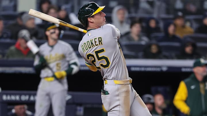 Apr 8, 2026; Bronx, New York, USA; Athletics designated hitter Brent Rooker (25) hits a run scoring sacrifice fly in the ninth inning against the New York Yankees at Yankee Stadium. Mandatory Credit: Wendell Cruz-Imagn Images