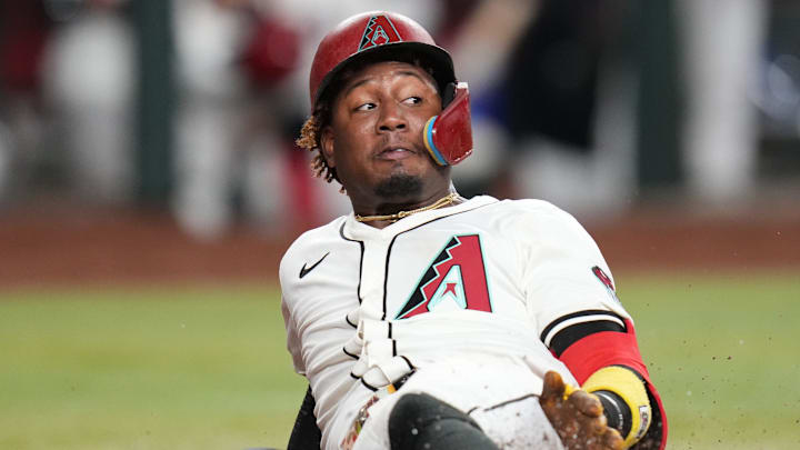 Arizona Diamondbacks baserunner Geraldo Perdomo (2) slides in safely to score a run against the Los Angeles Dodgers at Chase Field in Phoenix, on Sept. 24, 2025.