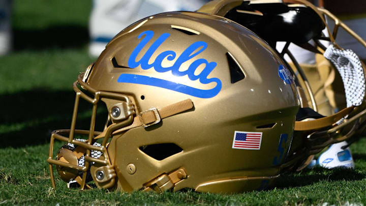 Nov 30, 2024; Pasadena, California, USA; UCLA Bruins helmets during pregame warmups before playing the Fresno State Bulldogs at Rose Bowl. Mandatory Credit: Robert Hanashiro-Imagn Images