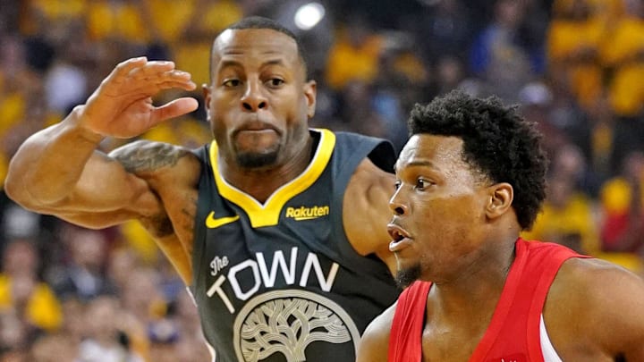 Toronto Raptors guard Kyle Lowry drives to the basket against Golden State Warriors guard Andre Iguodala.