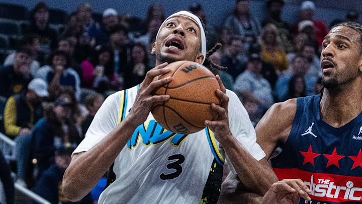 Nov 24, 2024; Indianapolis, Indiana, USA; Indiana Pacers center Moses Brown (3) shoots the ball while Washington Wizards forward Alexandre Sarr (20) defends in the first quarter at Gainbridge Fieldhouse. Mandatory Credit: Trevor Ruszkowski-Imagn Images