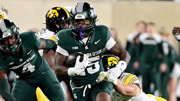 Oct 19, 2024; East Lansing, Michigan, USA;  Michigan State Spartans running back Kay'Ron Lynch-Adams (15) runs in the fourth quarter against the Iowa Hawkeyes at Spartan Stadium. Mandatory Credit: Dale Young-Imagn Images