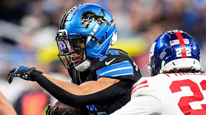 Detroit Lions wide receiver Amon-Ra St. Brown (14) runs against New York Giants cornerback Dru Phillips (22) 