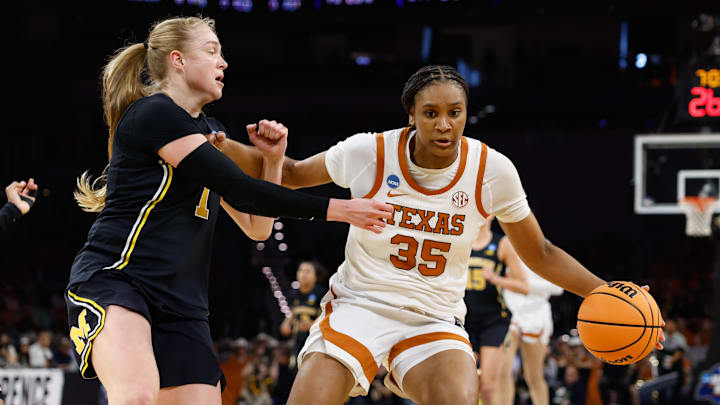 Texas Longhorns forward Madison Booker controls the ball as Michigan Wolverines guard Olivia Olson defends during the first half at Dickies Arena. 