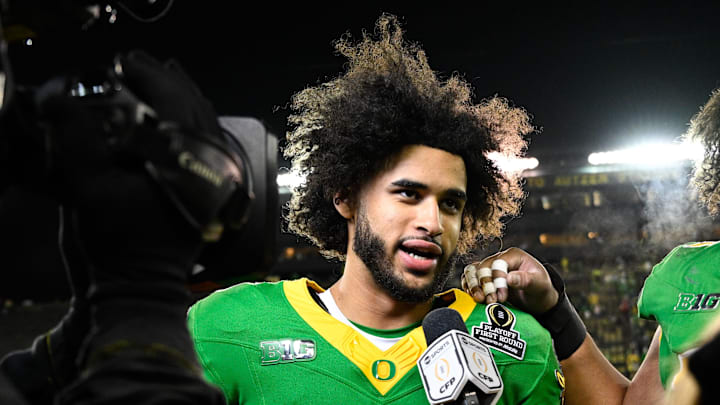 Dec 20, 2025; Eugene, OR, USA;  Oregon Ducks quarterback Dante Moore (5) is interviewed after the game against the James Madison Dukes at Autzen Stadium. Mandatory Credit: Troy Wayrynen-Imagn Images