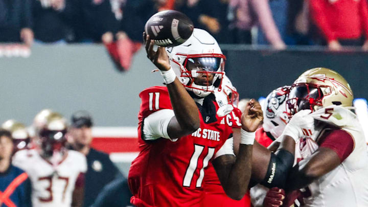 Nov 21, 2025; Raleigh, North Carolina, USA; NC State Wolfpack quarterback CJ Bailey (11) throws the ball during the first half of the game against Florida State Seminoles at Carter-Finley Stadium. Mandatory Credit: Jaylynn Nash-Imagn Images Nov 21, 2025; Raleigh, North Carolina, USA; NC State Wolfpack quarterback CJ Bailey (11) throws the ball during the first half of the game against Florida State Seminoles at Carter-Finley Stadium. Mandatory Credit: Jaylynn Nash-Imagn Images