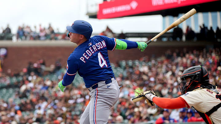 Apr 27, 2025; San Francisco, California, USA; Texas Rangers designated hitter Joc Pederson (4) hits a double against the San Francisco Giants during the first inning at Oracle Park. 