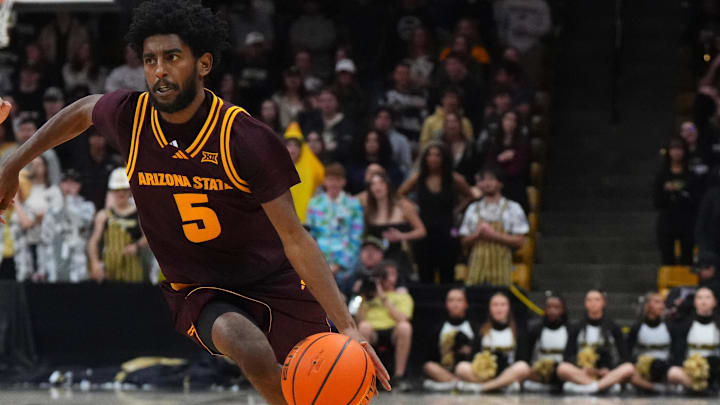 Feb 7, 2026; Boulder, Colorado, USA; Arizona State Sun Devils guard Maurice Odum (5) dribbles past Colorado Buffaloes center Elijah Malone (50) in the first half at the CU Events Center. Mandatory Credit: Ron Chenoy-Imagn Images