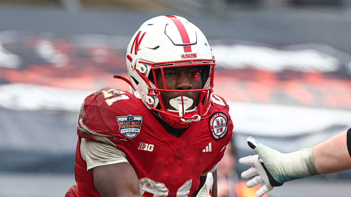 Dec 28, 2024; Bronx, NY, USA; Nebraska Cornhuskers running back Emmett Johnson (21) celebrates with teammates after a touchdown during the second half against the Boston College Eagles at Yankee Stadium. Mandatory Credit: Vincent Carchietta-Imagn Images