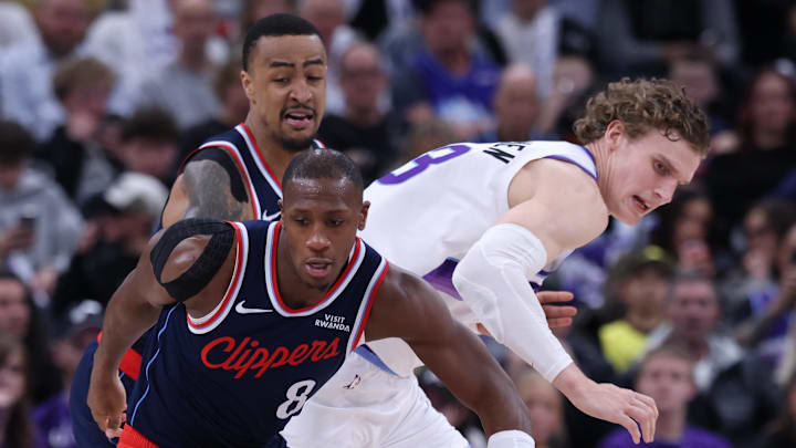 Jan 27, 2026; Salt Lake City, Utah, USA; LA Clippers guard Kris Dunn (8) knocks the ball away from Utah Jazz forward Lauri Markkanen (23) during the second half at Delta Center. Mandatory Credit: Rob Gray-Imagn Images