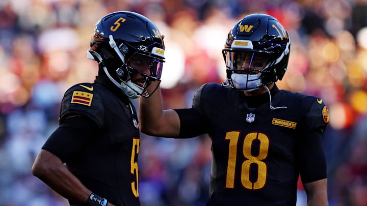Oct 27, 2024; Landover, Maryland, USA; Washington Commanders quarterback Jayden Daniels (5) and quarterback Marcus Mariota (18) talk to each other during the first half against the Chicago Bears at Commanders Field. Mandatory Credit: Peter Casey-Imagn Images Oct 27, 2024; Landover, Maryland, USA; Washington Commanders quarterback Jayden Daniels (5) and quarterback Marcus Mariota (18) talk to each other during the first half against the Chicago Bears at Commanders Field. Mandatory Credit: Peter Casey-Imagn Images