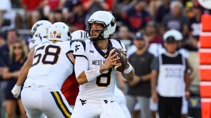 Oct 26, 2024; Tucson, Arizona, USA; West Virginia Mountaineers quarterback Nicco Marchiol (8) looks to throw the ball during the first quarter against the Arizona Wildcats at Arizona Stadium. Oct 26, 2024; Tucson, Arizona, USA; West Virginia Mountaineers quarterback Nicco Marchiol (8) looks to throw the ball during the first quarter against the Arizona Wildcats at Arizona Stadium.