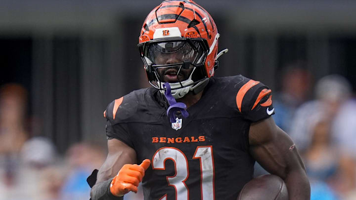 Sep 29, 2024; Charlotte, North Carolina, USA; Cincinnati Bengals running back Zack Moss (31) looks to elude Carolina Panthers linebacker Josey Jewell (47) during the third quarter at Bank of America Stadium. Mandatory Credit: Jim Dedmon-Imagn Images