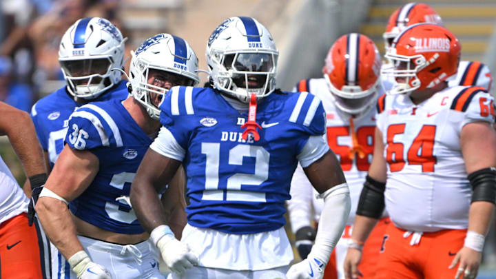 Sep 6, 2025; Durham, North Carolina, USA; Duke Blue Devils linebacker Tre Freeman (12) celebrates a tackle against Illinois Fighting Illini defensive back Torrie Cox Jr. (5) during the third quarter at Wallace Wade Stadium. Mandatory Credit: Zachary Taft-Imagn Images Sep 6, 2025; Durham, North Carolina, USA; Duke Blue Devils linebacker Tre Freeman (12) celebrates a tackle against Illinois Fighting Illini defensive back Torrie Cox Jr. (5) during the third quarter at Wallace Wade Stadium. Mandatory Credit: Zachary Taft-Imagn Images