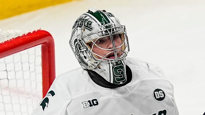 Michigan State goaltender Trey Augustine (1), left, tends net against Michigan forward Michael Hage (19) during the second period of Duel in the D at Little Caesars Arena in Detroit on Saturday, February 7, 2026. Michigan State goaltender Trey Augustine (1), left, tends net against Michigan forward Michael Hage (19) during the second period of Duel in the D at Little Caesars Arena in Detroit on Saturday, February 7, 2026.