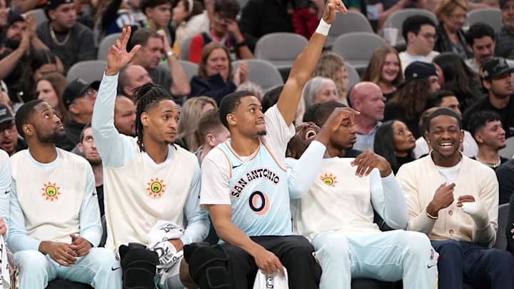 Mar 21, 2025; San Antonio, Texas, USA; San Antonio Spurs forward Keldon Johnson (0) and guard Devin Vassell (24) react to a basket during the fourth quarter against the Philadelphia 76ers at Frost Bank Center. Mandatory Credit: Dustin Safranek-Imagn Images